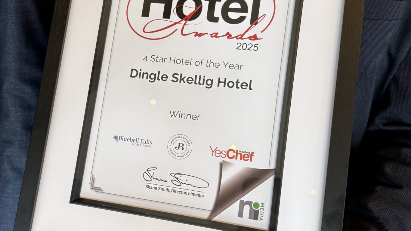 A person holding a framed certificate for the Irish Hotel Awards 2025, awarding Dingle Skellig Hotel as 4 Star Hotel of the Year.