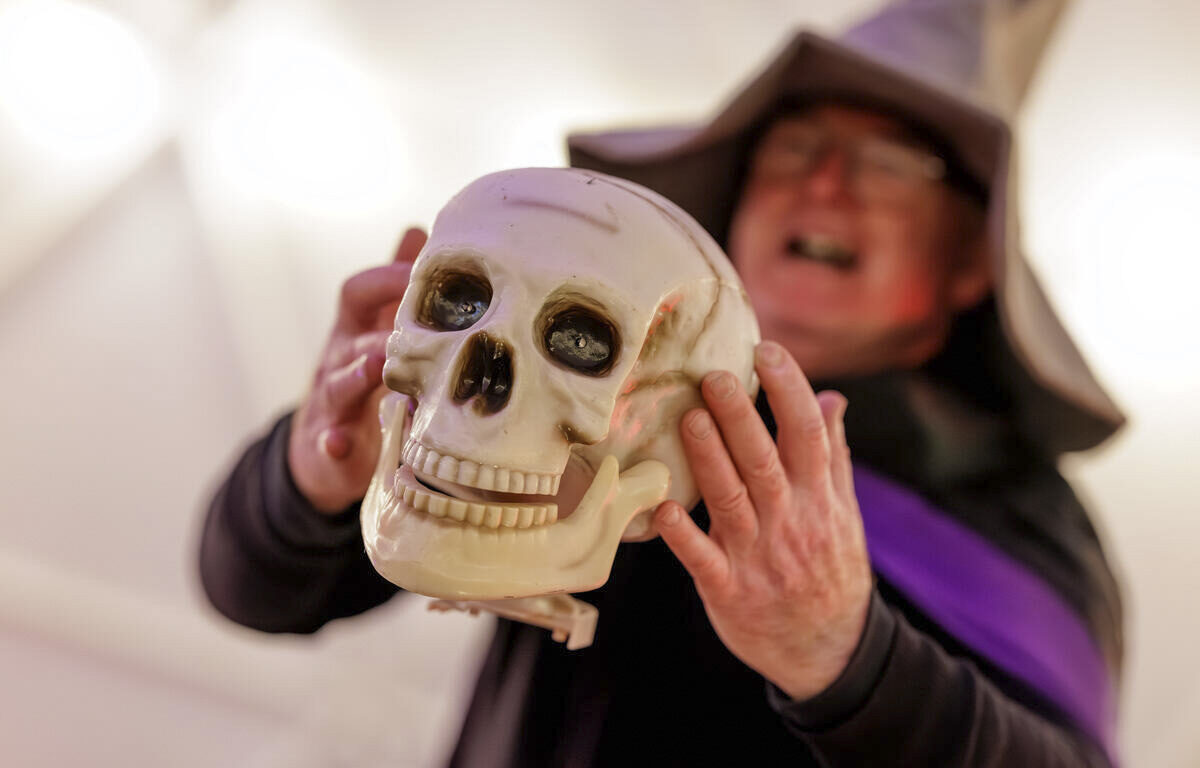 Enjoy a magical Halloween event with activities and themed decor at our hotel, featuring a host in a witch hat.