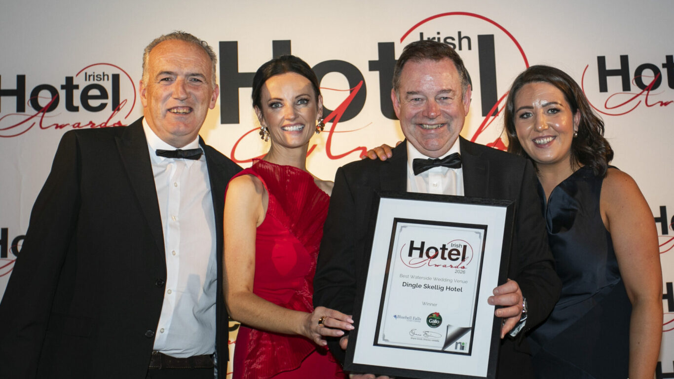 Hotel staff celebrating prestigious award win at gala event in elegant attire, showcasing excellence and hospitality.